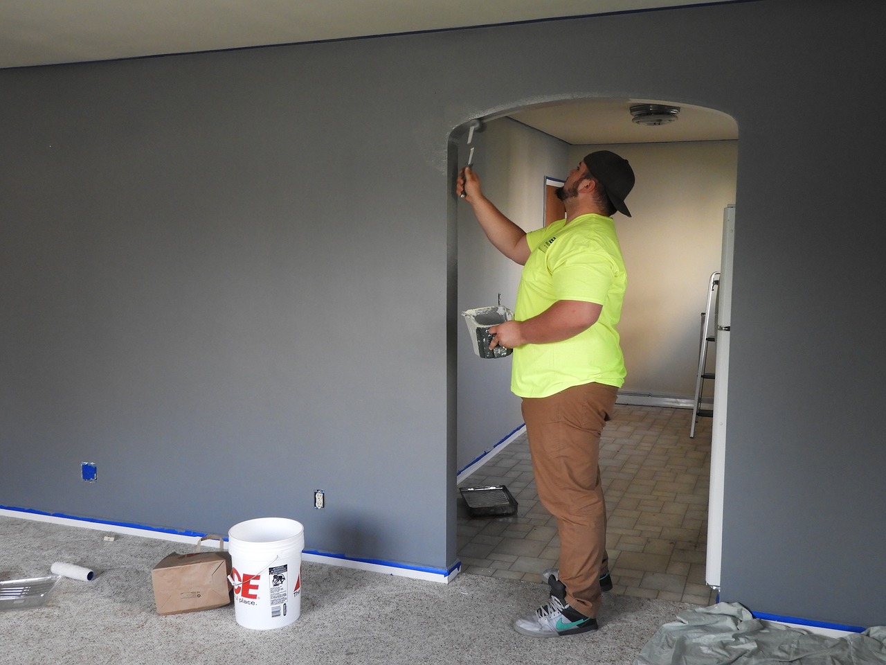 Residential drywall contractor painting a home